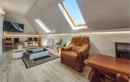 a living room with a leather chair and a table at 1 Bedroom Cozy Apartment In Kolobrzeg in Kołobrzeg