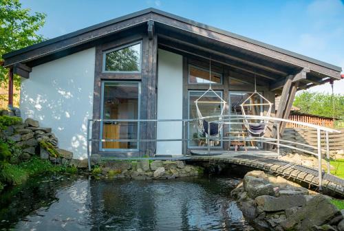 a house with a pond in front of it at Veranda in Slavske
