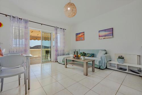 a living room with a couch and a table at The Island in Elounda