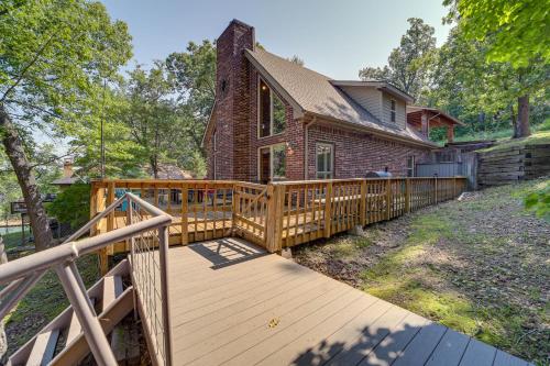 a home with a wooden ramp leading to a house at Boat Dock and Fire Pit Lakefront Paradise in Eucha! in Eucha