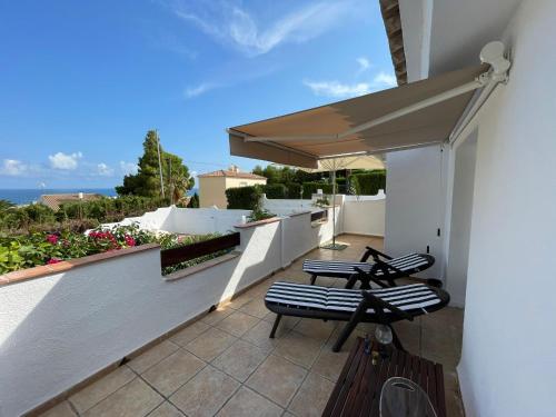 a patio with two chairs and an umbrella at Villa Mar in Alcossebre