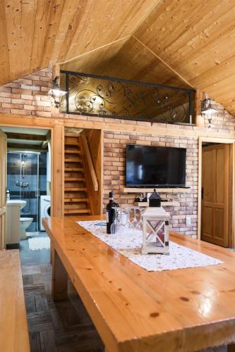 a large wooden table in a room with a tv at Holiday house Manuela in Kruševo