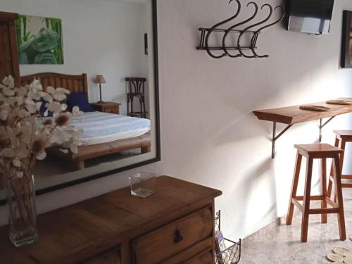 a bedroom with a bed and a mirror on the wall at piso con desayuno incluido y vistas a la montaña. in Monistrol