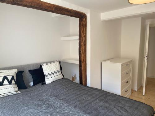 a bedroom with a large bed with a blue blanket at Tiny GetAway in Eberbach im Odenwald bei Heidelberg in Eberbach