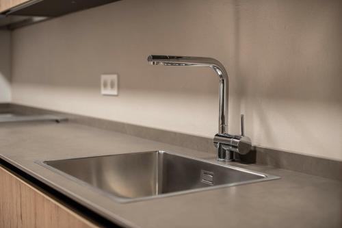 a kitchen sink with a faucet on a counter at Funcional y renovado apartamento en Iturrama in Pamplona