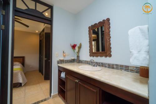 a bathroom with a sink and a mirror at Bahia Encantada beach front proyect, Jaco Paradise in Jacó