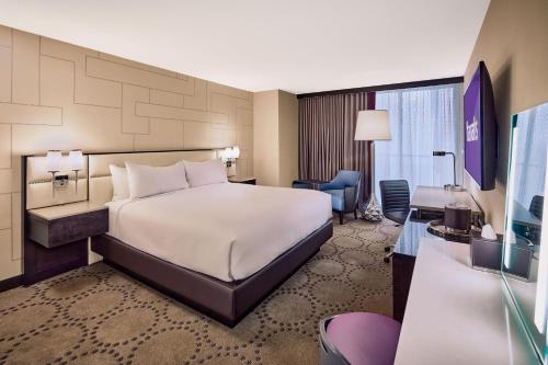 a hotel room with a bed and a desk at Beautiful Unit in Harrah's Casino Strip LAS VEGAS in Las Vegas