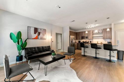 a living room with a couch and chairs and a kitchen at Urban Nest ATL in Atlanta