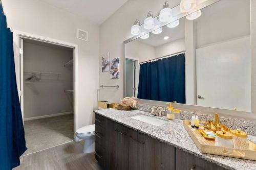 a bathroom with a sink and a mirror at East Atlanta Retreat Haven of Fun and Comfort! in Atlanta