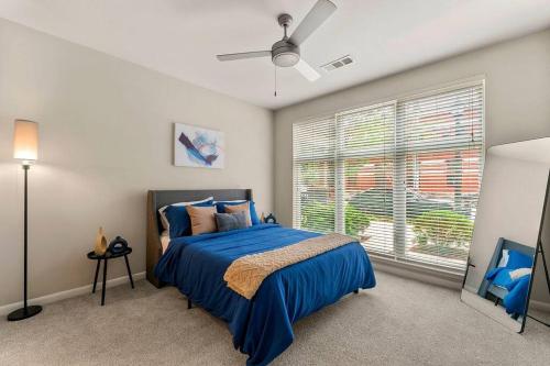 a bedroom with a blue bed and a window at East Atlanta Retreat Haven of Fun and Comfort! in Atlanta