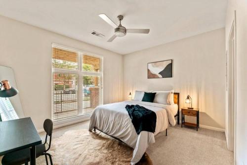 a bedroom with a bed with a ceiling fan and a window at Urban Nest ATL in Atlanta
