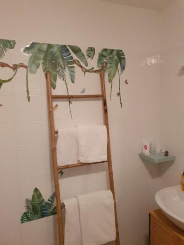 a bathroom with a towel ladder and a sink at L EVASION in Cuxac-Cabardès