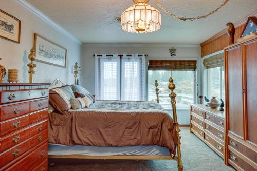 a bedroom with a bed and a chandelier at Tacoma Home on Steilacoom Lake with Dock! in Tacoma