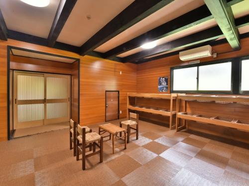 a room with wooden walls and tables and chairs at Arya Hotel Alpin Route - Vacation STAY 81598v in Omachi