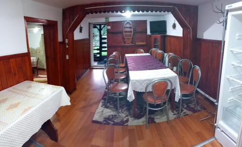 a dining room with a table and chairs in it at PERLA CĂLIMANILOR in Vatra Dornei