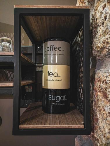 a bottle of coffee sitting in a box at Three Dots Boutique Suites in Soúlion