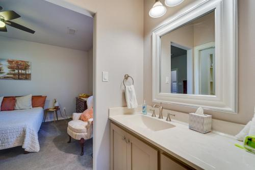 a bathroom with a sink and a mirror and a bed at Spacious Lubbock Home with Private Pool and Yard! in Lubbock