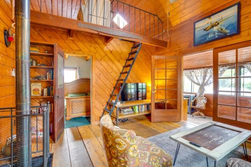 a living room with a spiral staircase in a wooden house at Bisbee Vacation Rental with Mountain Views and Sunroom in Bisbee