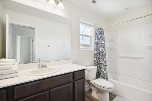 a bathroom with a sink and a toilet and a mirror at Carson City Retreat about 1 Mi to Hot Springs! in Carson City