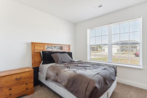 a bedroom with a bed and a window at Charming St Robert Home Near Downtown Waynesville! in Waynesville