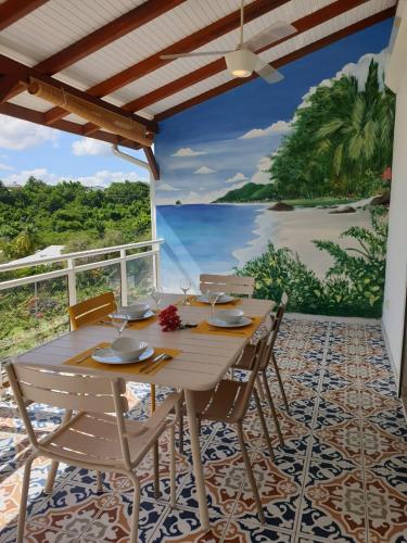 a dining room with a table and chairs and a view of the ocean at Villa Stone pour 8 personnes, piscine chauffée 5 euros par jour, accès PMR, 5 étoiles in Sainte-Luce