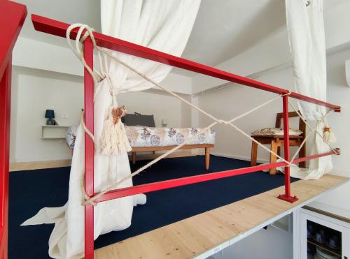 a room with a red and white bed in a room at La dimora del RAIS in Tonnara di Bonagia