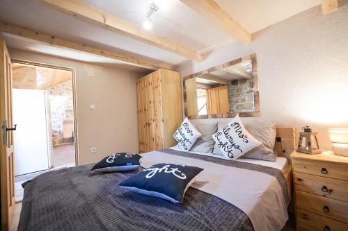 a bedroom with a large bed with pillows on it at Holiday house Manuela in Kruševo