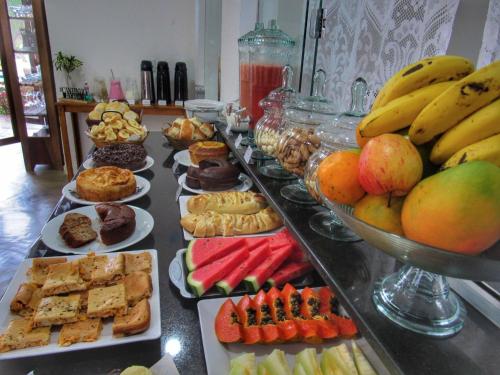 a buffet with many different types of food on a table at Pousada Sr. Ivan in Serra do Cipo