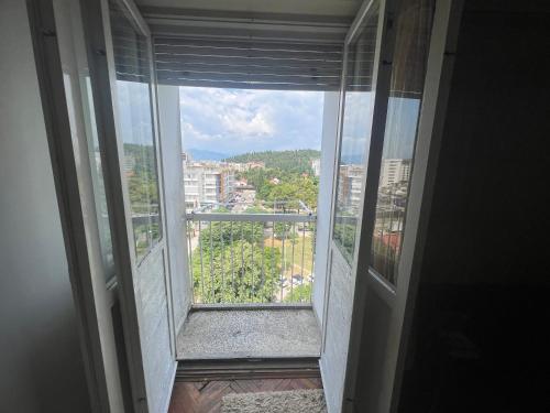 a room with a window with a view of a city at A-D free wi-fi internet, air conditioner,free parking in Podgorica