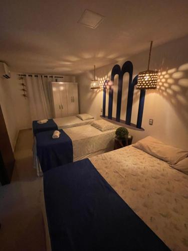 a bedroom with two beds and skis on the wall at Residencial Temporada Aracaju in Aracaju