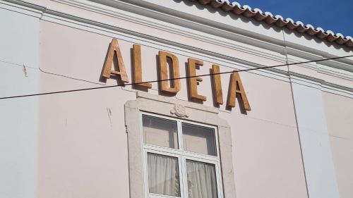 aania sign on the side of a white building at Aldeia de Portimão in Portimão
