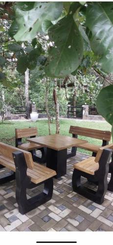 a picnic table and benches in a park at White House Family Stay in Maspota