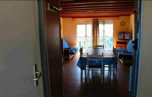 a room with a table and a living room with a couch at APPARTEMENT ESQUIEZE SERE in Luz-Saint-Sauveur