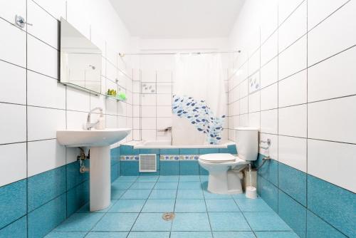 a blue and white bathroom with a toilet and a sink at Stay in calm in Kavála