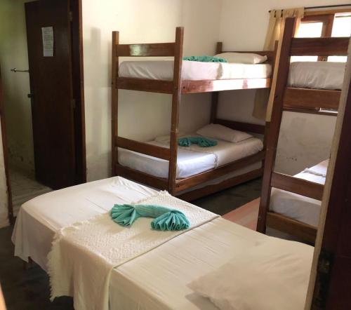 a room with three bunk beds in a room at Pousada Aba da Serra in São Joaquim do Monte