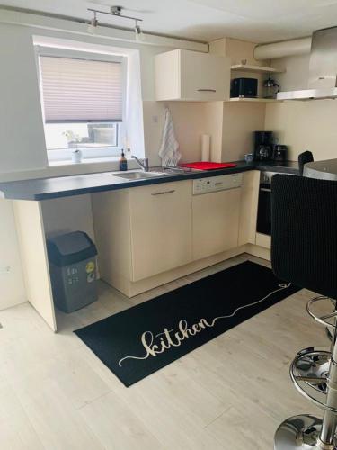 a kitchen with a counter and a kitchen rug on the floor at Practical Loft Comfort near Munich in Germering