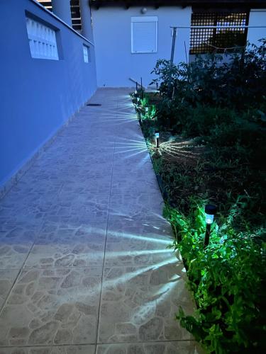 a garden with lights on the side of a building at La Casa di Leone Casa Sorella in Svoúrou Metókhion