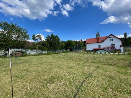 a large field with a white house in the background at Wellness chalupa Soběšice - brána na Šumavu in Soběšice