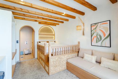 a living room with a couch and a crib at Apágkio Filoxenia in Archangelos