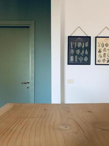 a room with a wooden floor and two pictures on the wall at Agriturismo La Terrazza su Farfa in Castelnuovo di Farfa