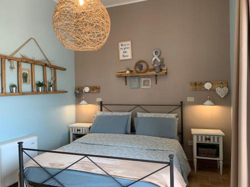 a bedroom with a bed and a chandelier at Agriturismo La Terrazza su Farfa in Castelnuovo di Farfa