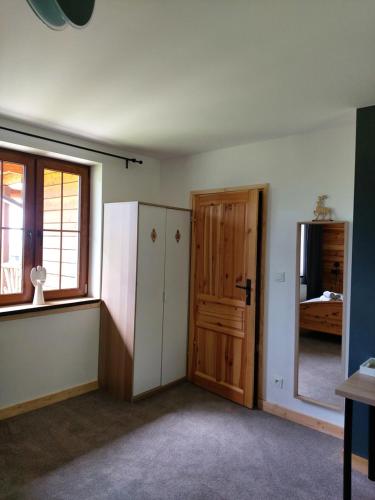 an empty room with a door and a window at Żaroowka in Międzybrodzie Żywieckie