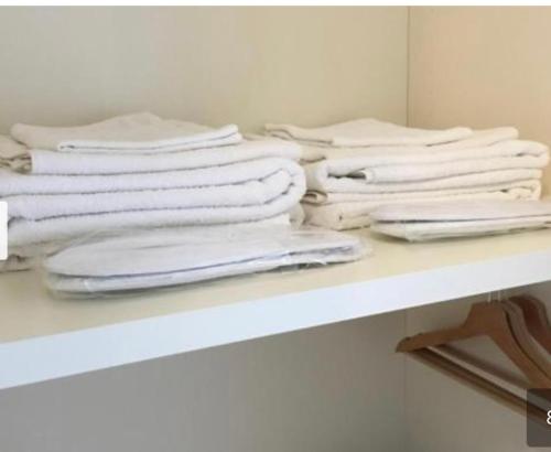 a pile of white towels sitting on a table at Affittacamere Seveso in Milan