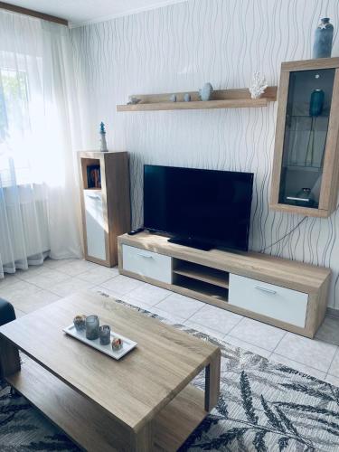 a living room with a television and a coffee table at Ostsee Ferienwohnung in Scharbeutz