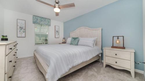 a bedroom with a bed and a ceiling fan at 8972 Amelia Downs in Orlando
