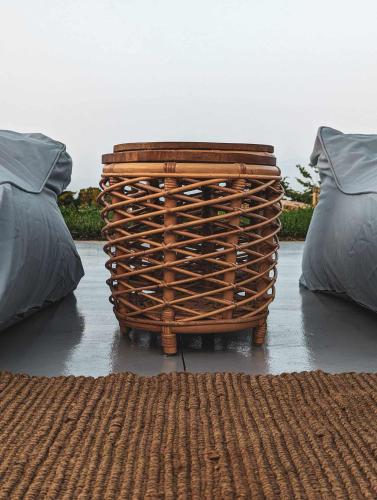 a wicker basket sitting next to two beds at Three Dots Boutique Suites in Soúlion