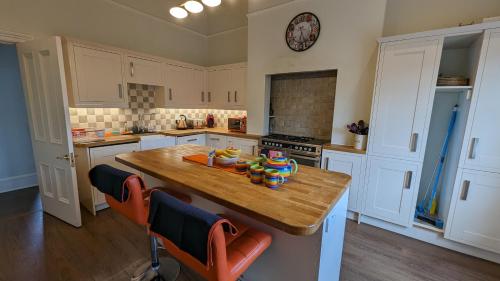 a kitchen with a wooden table in a kitchen at Cotswold VIP Regency Lodge in Cheltenham