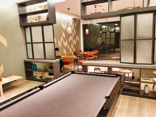a billiard room with a pool table and tables at Velasco MaiaHome-POLANCO Depa con alberca/gym/spa/jacuzzi + 3BR in Mexico City