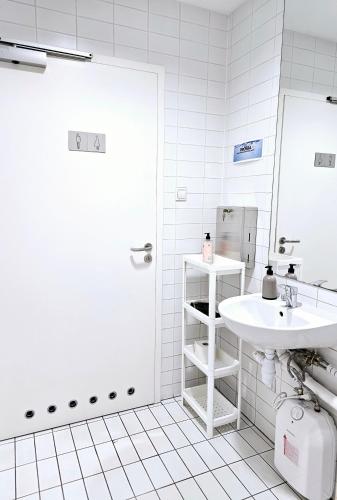 a white bathroom with a sink and a mirror at Noclegi Wałbrzych Centrum in Wałbrzych