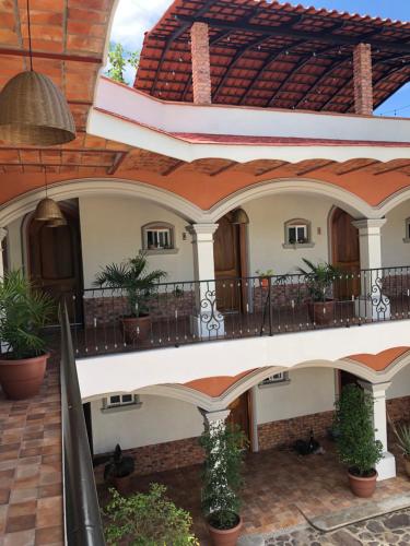 a house with a balcony and a roof at Mountain View Lofts Guayabitos in Rincon de Guayabitos